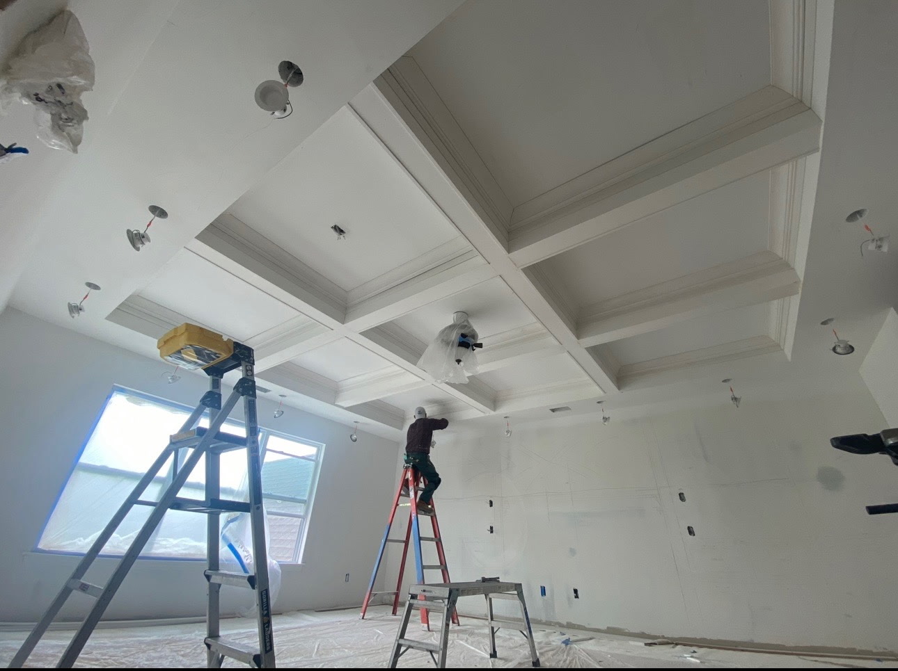 Colonial Crete carpenter installing a custom coffered ceiling on Long Island